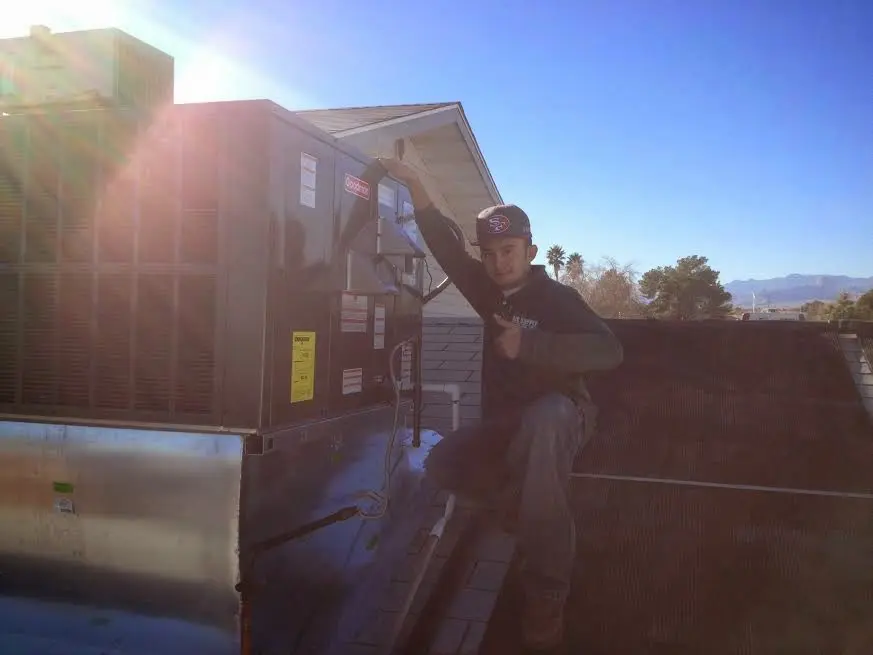 HVAC technician performing HVAC Inspection on a rooftop unit in Watchung